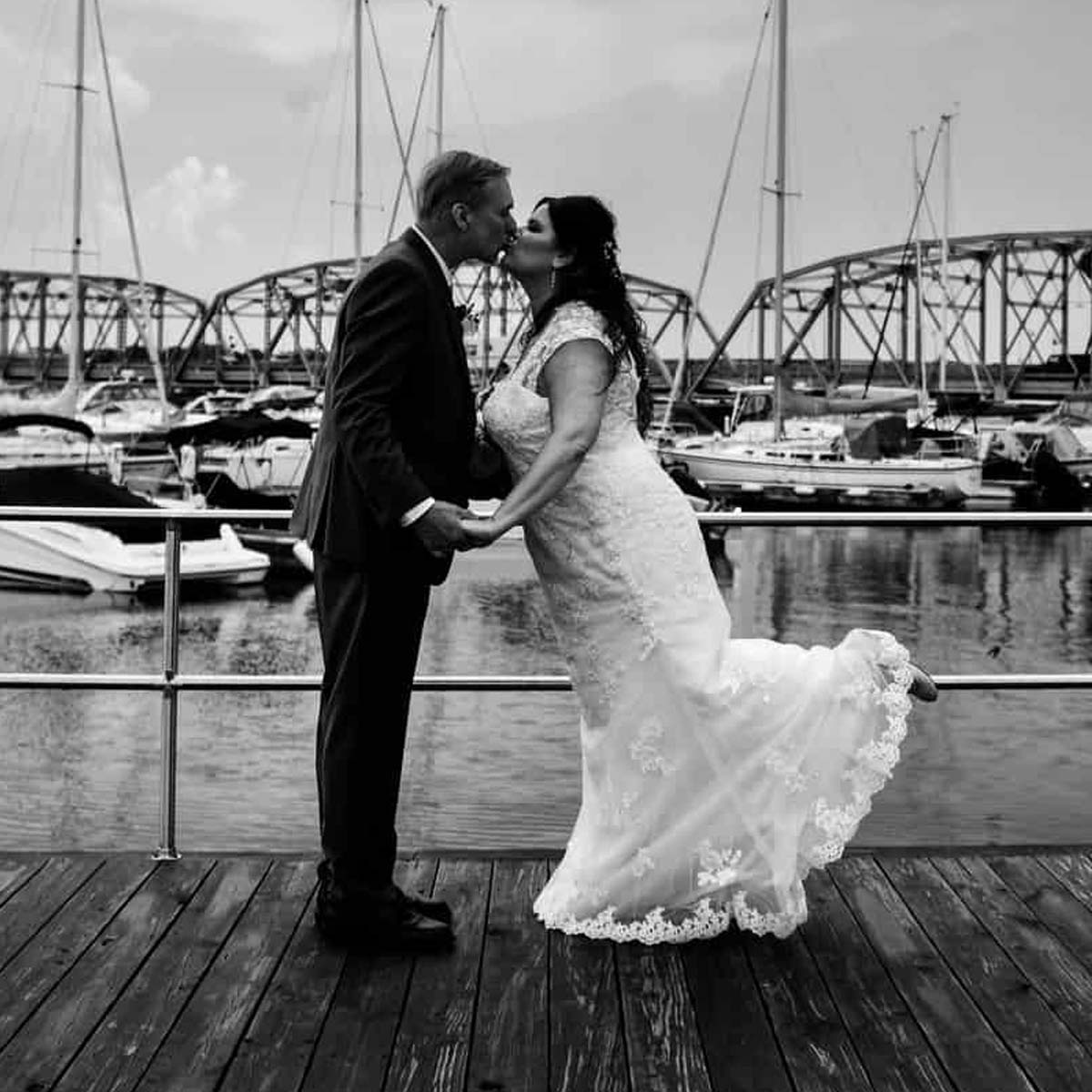 Sonny's Italian Kitchen and Pizzeria in Door County Wisconsin on Sturgeon Bay outdoor waterfront bride groom first kiss