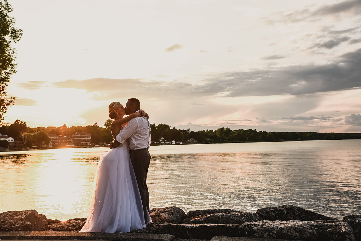 Bride and groom kiss outside Sturgeon Bay near Sonny's Italian Kitchen in Door County Wisconsin, offering the most picturesque weddings on Sturgeon Bay