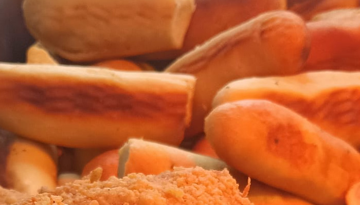 Breadsticks and fried food stacked together in warm, yellow lighting at an Italian Restaurant.