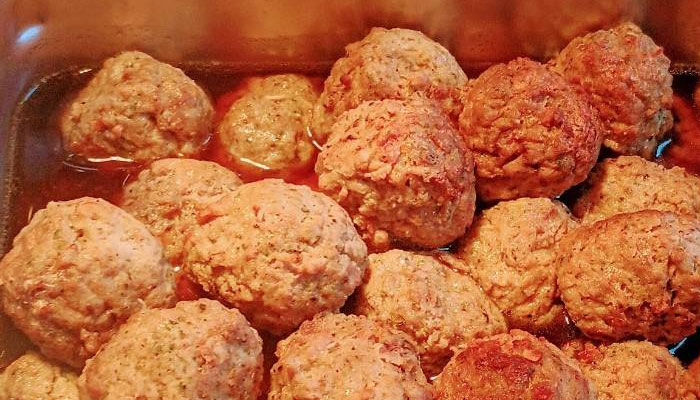 Baked meatballs in sauce, just like at Sonny’s Italian Kitchen & Pizzeria, in a baking dish.
