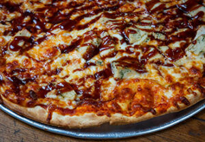 Close-up of pizza at an Italian restaurant in Sturgeon Bay, with melted cheese and barbecue sauce.