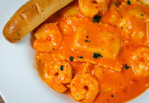 Shrimp and ravioli in creamy tomato sauce—an Italian Restaurant classic, served with a breadstick.
