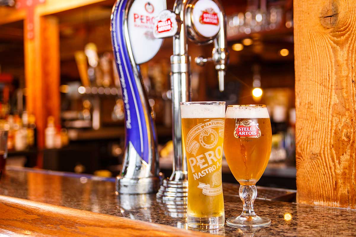 Two draft beers in Sonny’s Italian Kitchen & Pizzeria glasses on a Sturgeon Bay bar counter.