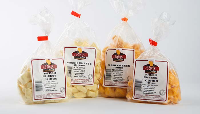 Four bags of Ron’s fresh cheese curds—Sturgeon Bay favorites—on a clean white background.