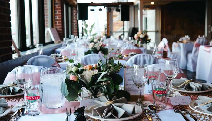 Elegant banquet tables at Sonny’s Italian Kitchen, featuring floral centerpieces and glassware.