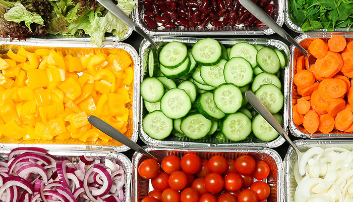 Fresh vegetables in trays at this Sturgeon Bay waterfront restaurant: cucumbers, carrots, greens.
